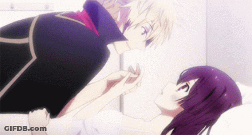 A Man Is Kissing A Woman 'S Hand While She Is Laying In A Hospital Bed . GIF