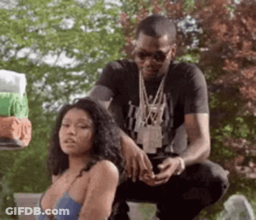 A Man Is Kneeling Down Next To A Woman In A Blue Bra . GIF