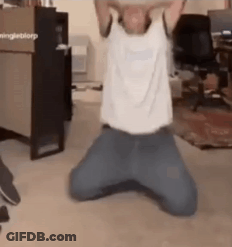 A Man Is Kneeling Down On The Floor With His Arms Outstretched . GIF