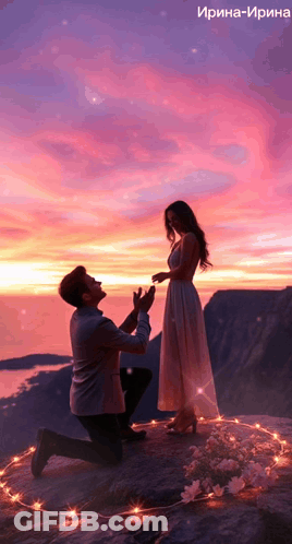 A Man Is Kneeling Down To Propose To A Woman In Front Of A Pink Sky GIF