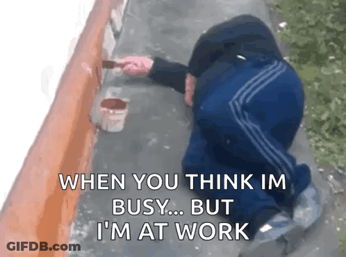 A Man Is Kneeling Down While Painting A Wall With A Brush And A Bucket Of Paint . GIF