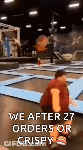 A Man Is Kneeling On A Trampoline With The Words `` We After 27 Orders Or Crispy '' Written On It . GIF
