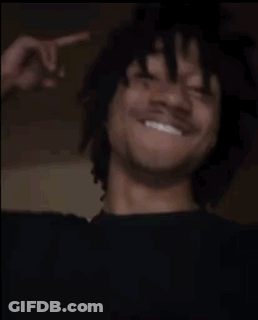 A Man Is Laughing And Giving The Middle Finger While Wearing A Black Shirt . GIF