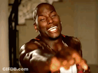 A Man Is Laughing And Pointing At The Camera With His Hands . GIF