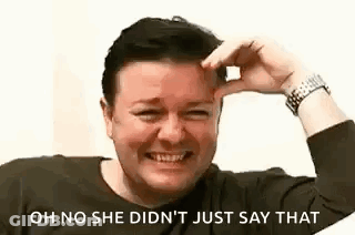 A Man Is Laughing And Touching His Forehead With His Hand . GIF