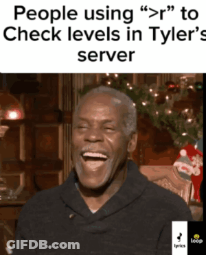 A Man Is Laughing In Front Of A Christmas Tree GIF