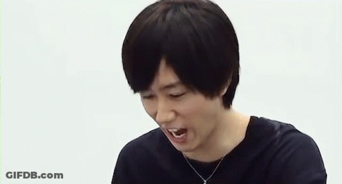A Man Is Laughing While A Person Points At Him . GIF