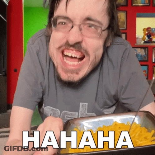 A Man Is Laughing While Holding A Tray Of Macaroni Cheese GIF