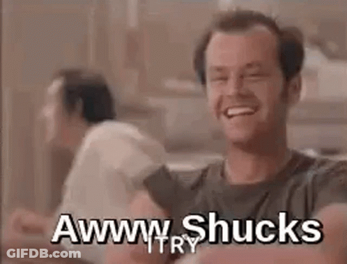 A Man Is Laughing While Sitting At A Table With Another Man . GIF