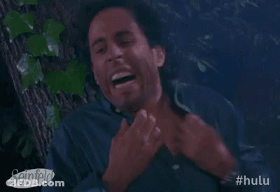 A Man Is Laughing While Sitting In A Tree . GIF