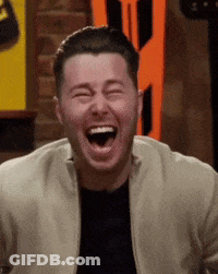 A Man Is Laughing With His Mouth Wide Open . GIF