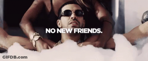 A Man Is Laying In A Bathtub Surrounded By Women With The Words No New Friends Below Him GIF