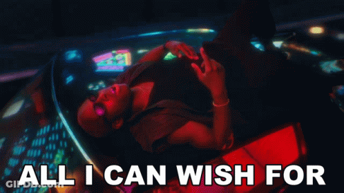 A Man Is Laying In A Car With The Words All I Can Wish For GIF
