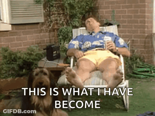 Man Lying In Chair Next To Dog GIF