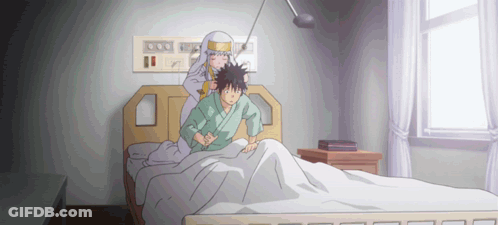 A Man Is Laying In A Hospital Bed While A Woman Stands Behind Him GIF
