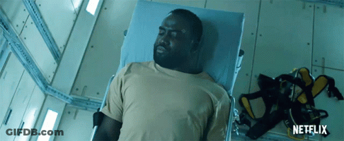 A Man Is Laying In A Hospital Bed With A Netflix Logo On The Bottom GIF