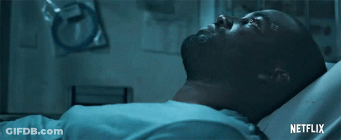 A Man Is Laying In A Hospital Bed With A Netflix Logo On The Bottom GIF