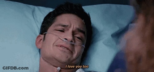A Man Is Laying In A Hospital Bed With An Oxygen Mask And Crying . GIF