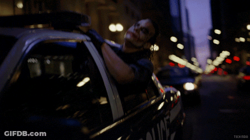 A Man Is Laying In A Police Car With The Words Tech Noir On The Bottom GIF