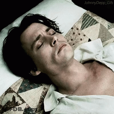 A Man Is Laying In Bed With His Eyes Closed And The Words Johnny Depp Gifs On The Bottom GIF