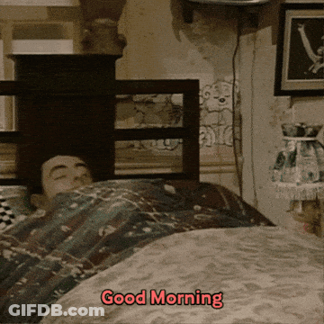 A Man Is Laying In Bed With The Words " Good Morning " Written On The Bottom GIF