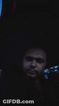 A Man Is Laying In The Dark With His Eyes Closed GIF
