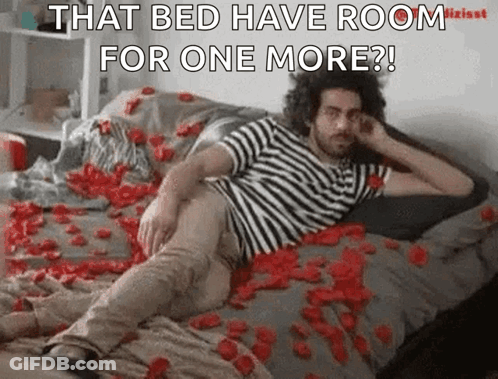 A Man Is Laying On A Bed Covered In Rose Petals And Says That Bed Have Room For One More GIF
