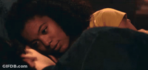 A Man Is Laying On A Bed With A Woman Holding His Arm GIF