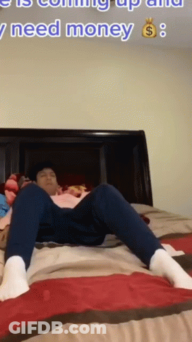 A Man Is Laying On A Bed With The Words " I Need Money " In The Corner GIF