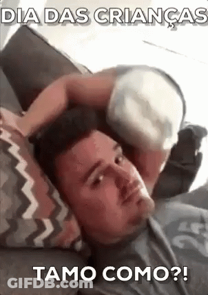 A Man Is Laying On A Couch With A Baby On Top Of His Head . GIF