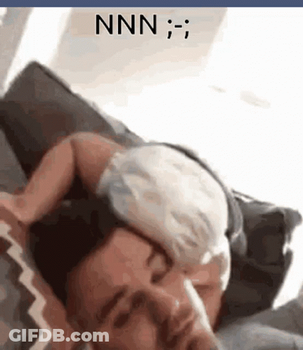 A Man Is Laying On A Couch With A Cat On His Head And The Word Nnn Is On The Bottom GIF