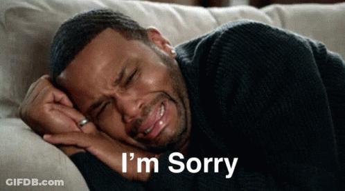 A Man Is Laying On A Couch With His Eyes Closed And The Words I 'M Sorry Written Below Him GIF