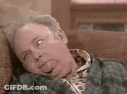 Man Lying On Couch Looking At Camera GIF