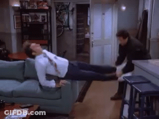 A Man Is Laying On A Couch With His Legs Up GIF