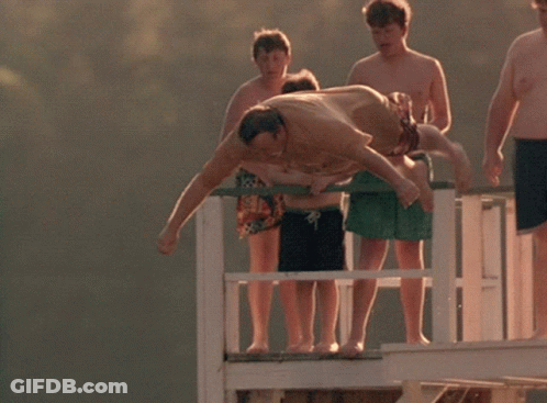A Man Is Laying On A Giant Inflatable Shark That Says The Blob On It GIF
