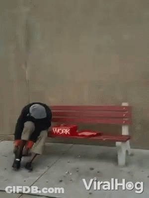 A Man Is Laying On A Red Bench With A Pizza Box On It . GIF