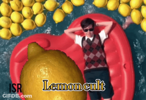 A Man Is Laying On A Red Raft Surrounded By Lemons And The Word Lemon Cult Is On The Bottom Right GIF