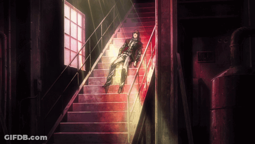 A Man Is Laying On A Set Of Stairs With A Sign That Says Danger GIF