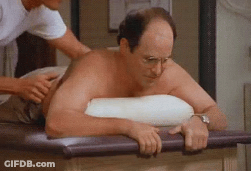 A Man Is Laying On A Table Getting A Massage From A Massage Therapist . GIF