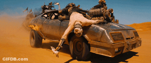 A Man Is Laying On The Back Of A Dirty Car GIF