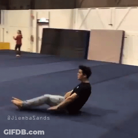 A Man Is Laying On The Floor In A Gym With The Words Juliembasands Written On The Bottom GIF