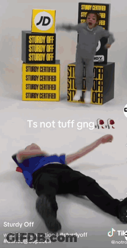 A Man Is Laying On The Floor In Front Of A Jd Sign GIF