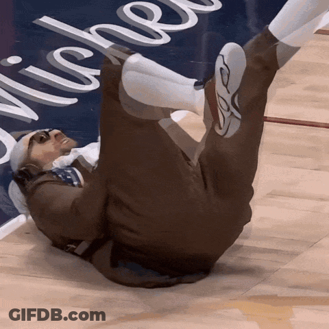 A Man Is Laying On The Floor In Front Of A Sign That Says " Michel " GIF
