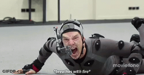 A Man Is Laying On The Floor Wearing A Helmet And Knee Pads And Breathing With Fire . GIF