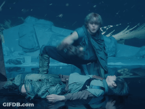 A Man Is Laying On The Floor With Another Man GIF