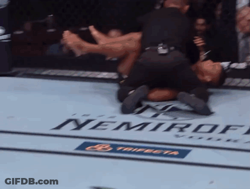 A Man Is Laying On The Ground In A Boxing Ring With A Nemiroff Logo On The Floor GIF