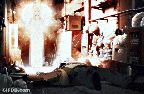 A Man Is Laying On The Ground In A Room With Boxes Of Sapporo Beer GIF