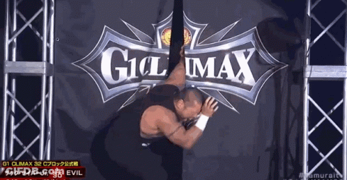 A Man Is Laying On The Ground In Front Of A Sign That Says Climax GIF