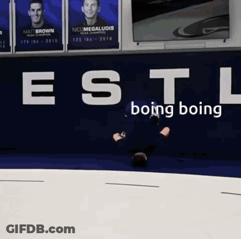 A Man Is Laying On The Ground In Front Of A Wall That Says " Estl Boing Boing " GIF