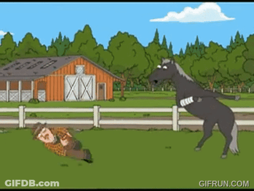A Man Is Laying On The Ground While A Horse Stands On Its Hind Legs GIF
